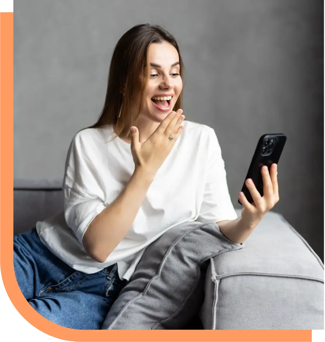 A woman smiles with delight while looking at her phone, representing the satisfaction and loyalty driven by Peak Support’s 24/7 e-commerce customer service. Peak Support builds long-term partnerships through exceptional support.