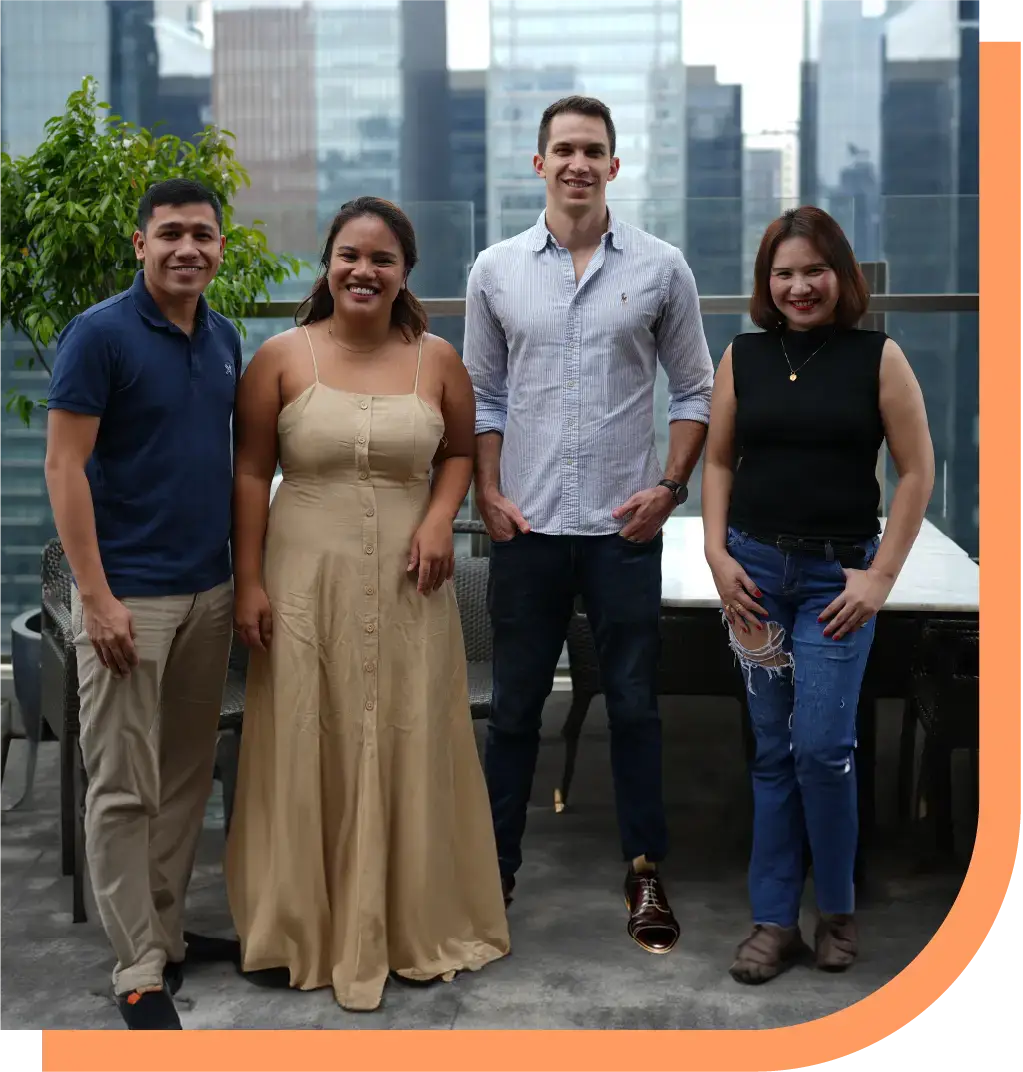 Four Peak Support team members stand together smiling in front of a city skyline, representing the company’s expertise in supporting retail and e-commerce brands with scalable, people-first customer service. Peak Support helps companies scale with people-first CX solutions.