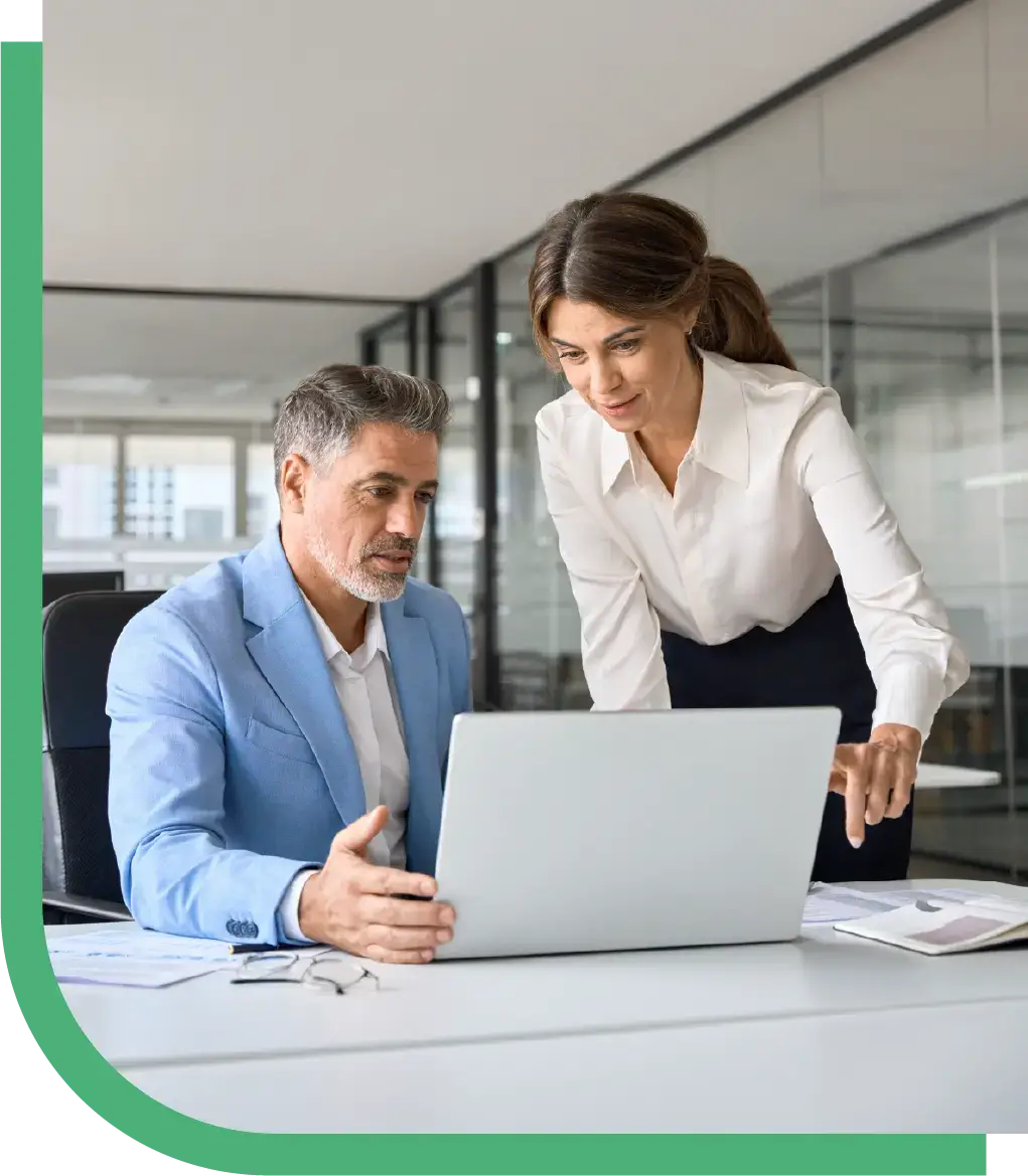 Two professionals review information on a laptop, representing Peak Support’s commitment to protecting e-commerce brands with secure, compliant customer support solutions. Peak Support provides trusted, data-driven outsourcing services.